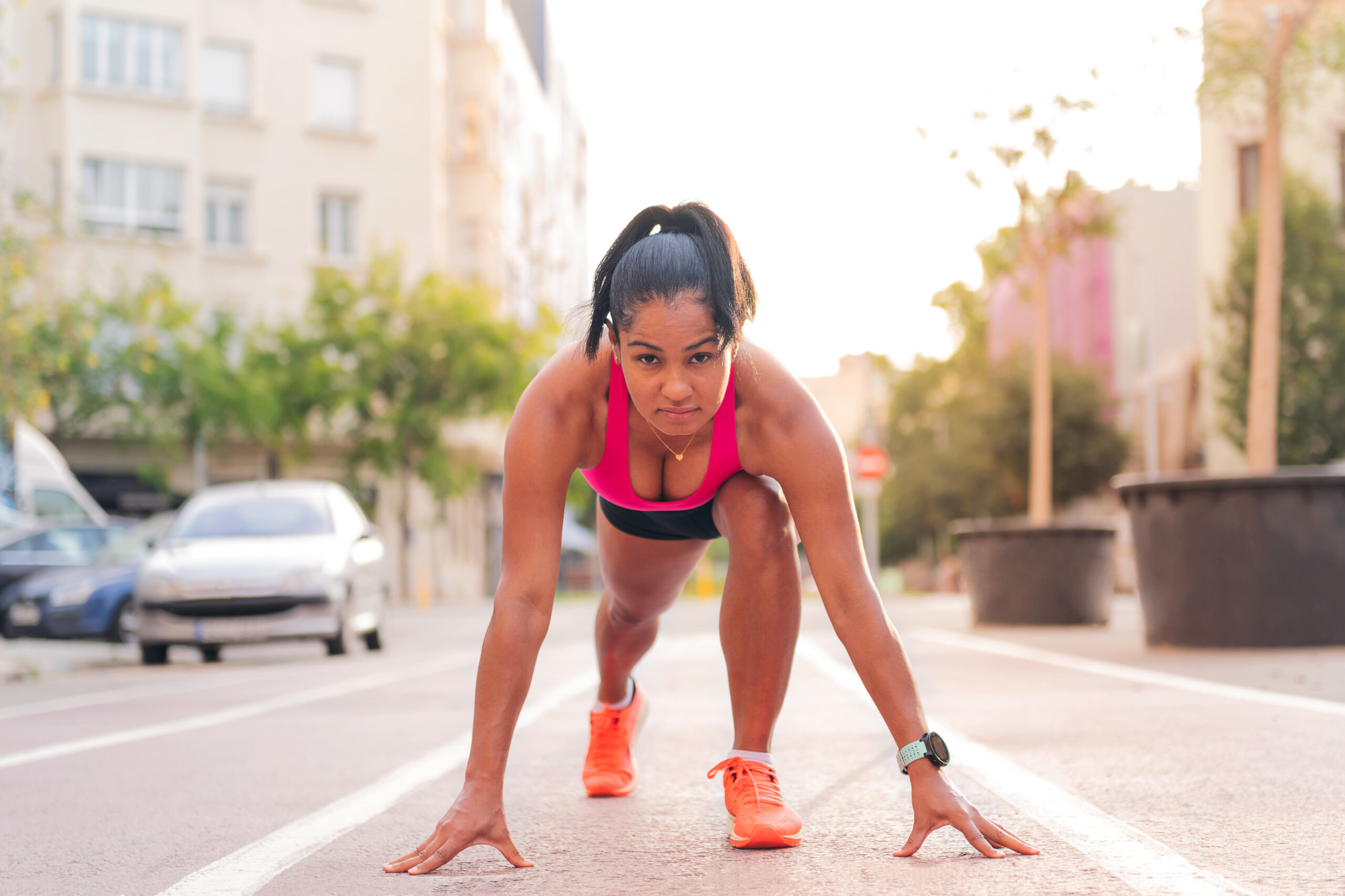 sportswoman at starting line of athletics track