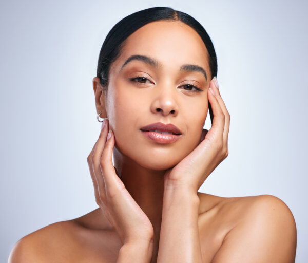 woman, portrait and clear skincare in studio, healthy and hands for beauty on white background. female person, cosmetics and touch soft or smooth skin, facial treatment and foundation for dermatology