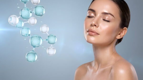 woman with closed eyes surrounded by teal bubble molecule graphic representing hydrating skincare serum science