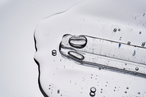 clear serum texture with pipette on white background