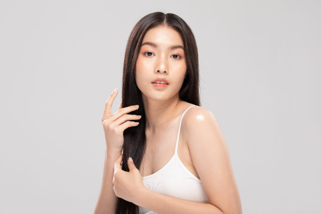 beautiful asian woman with shiny black straight long hair looking at camera smile with clean and fresh skin happiness and cheerful,isolated on gray background,beauty hairs concept