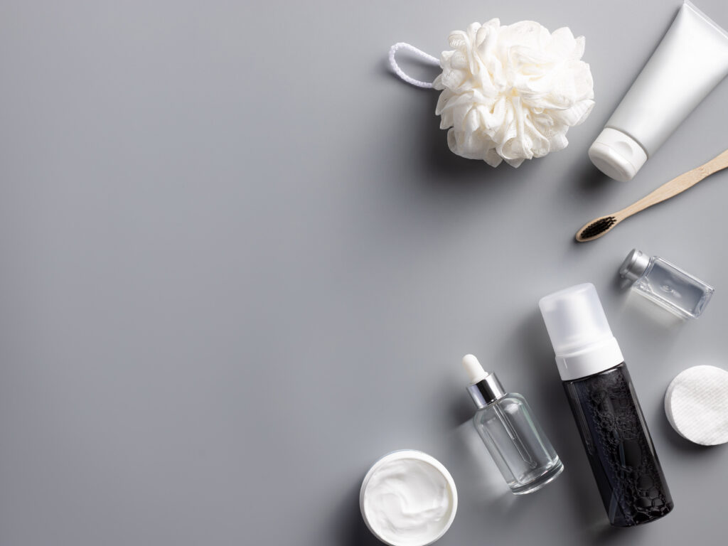 set of cosmetics for skin and body care on a gray background