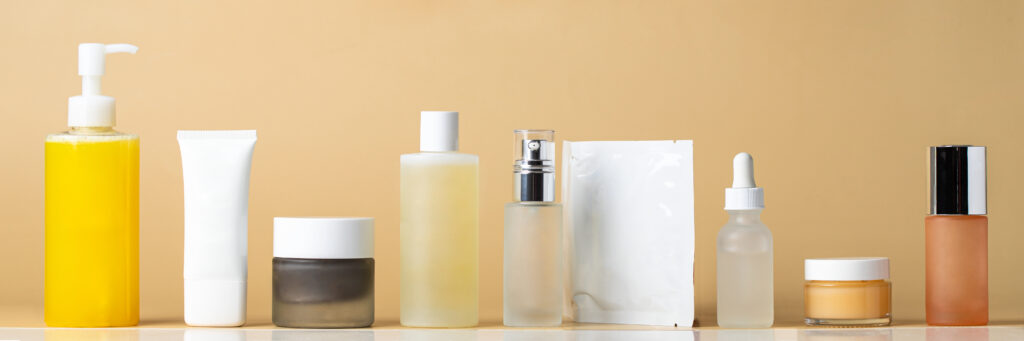 10 step skincare routine for healthy radiant skin cleanser,toner, essence, serum, mask, cream and spf bottles on packaging on beige background. beauty and cosmetic web banner.
